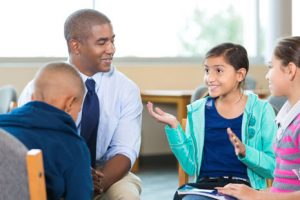 social worker sitting in group session